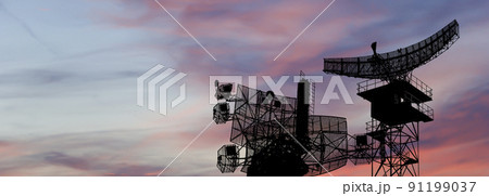 Air defense radars of military mobile anti aircraft systems, modern army industry on the background of the sunset orange sky, Russia 91199037