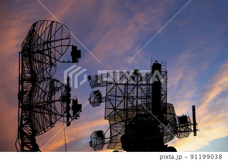 Air defense radars of military mobile anti aircraft systems, modern army industry on the background of the sunset orange sky, Russia 91199038