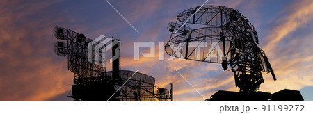 Air defense radars of military mobile anti aircraft systems, modern army industry on the background of the sunset orange sky, Russia Air defense radars of military mobile anti aircraft systems, modern army industry on the background of the sunset orange sky, Russia 91199272