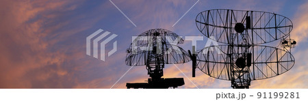 Air defense radars of military mobile anti aircraft systems, modern army industry on the background of the sunset orange sky, Russia Air defense radars of military mobile anti aircraft systems, modern army industry on the background of the sunset orange sky, Russia 91199281