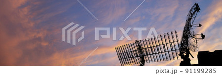 Air defense radars of military mobile anti aircraft systems, modern army industry on the background of the sunset orange sky, Russia 91199285