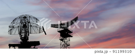 Air defense radars of military mobile anti aircraft systems, modern army industry on the background of the sunset orange sky, Russia 91199310