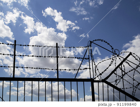 Contour of barbed wire on background beautiful clouds and sky Contour of barbed wire on background beautiful clouds and sky 91199840
