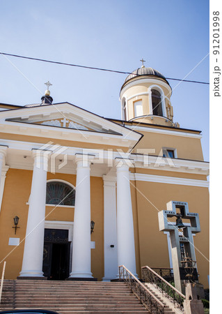 entrance to a large catholic church with white columns 91201998