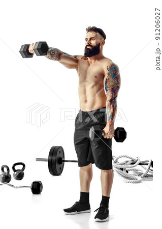 Muscular bodybuilder guy doing exercises with dumbbells over white background Muscular bodybuilder guy doing exercises with dumbbells over white background 91206027