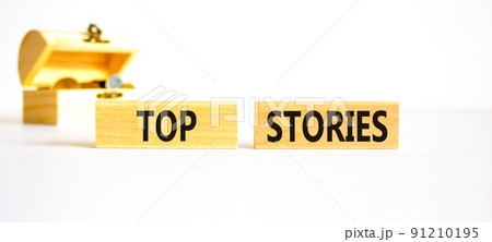 Top stories symbol. Concept words Top stories on wooden blocks on a beautiful white table white background. Wooden chest with coins. Business story and top stories concept, copy space. Top stories symbol. Concept words Top stories on wooden blocks on a beautiful white table white background. Wooden chest with coins. Business story and top stories concept, copy space. 91210195