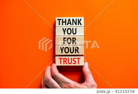 Thank you for trust symbol. Concept words Thank you for your trust on wooden blocks on a beautiful orange table orange background. Businessman hand. Business and thank you for trust concept. Thank you for trust symbol. Concept words Thank you for your trust on wooden blocks on a beautiful orange table orange background. Businessman hand. Business and thank you for trust concept. 91210258