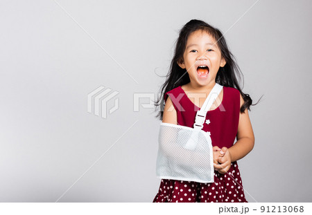 Little cute kid girl 3-4 years old hand bone broken from accident with arm splint in studio shot isolated 91213068