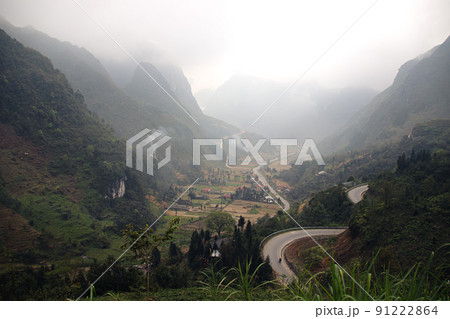 Winding mountain road among the karst mountains in Dong Van Karst Plateau Geopark in North Vietnam 91222864