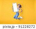 Excited young Asian woman holding smartphone, showing blank screen 91228272