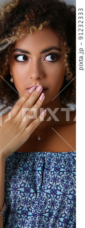 Beautiful latin young woman with shocked or surprised facial expression close mouth with hand 91232333