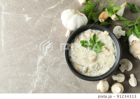 Concept of tasty food with mushroom sauce on gray textured background Concept of tasty food with mushroom sauce on gray textured background 91234313