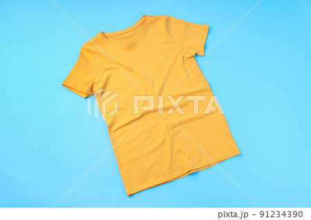 Blank yellow t-shirt with space for print on blue background 91234390