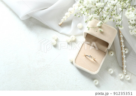 Concept of wedding accessories with wedding ring, close up Concept of wedding accessories with wedding ring, close up 91235351