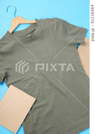 Blank t-shirt, bag and carton sheet on blue background 91236464