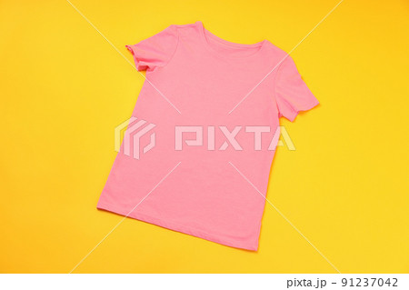 Blank pink t-shirt with space for print on yellow background Blank pink t-shirt with space for print on yellow background 91237042