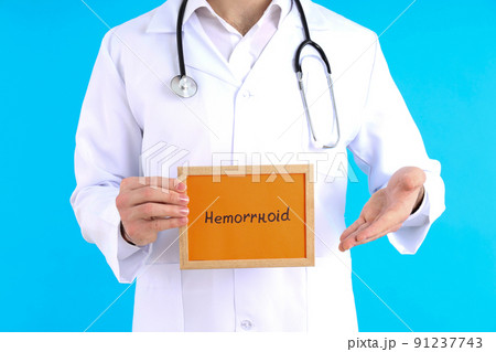 Doctor with text Hemorrhoid on blue background 91237743