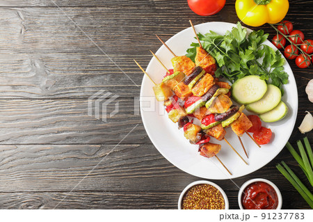 Concept of tasty food with chicken shashlik on dark wooden background 91237783