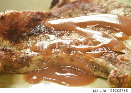 grilled pork chop steak with french fries and slice pineapple dipping gravy sauce on plate grilled pork chop steak with french fries and slice pineapple dipping gravy sauce on plate 91238788