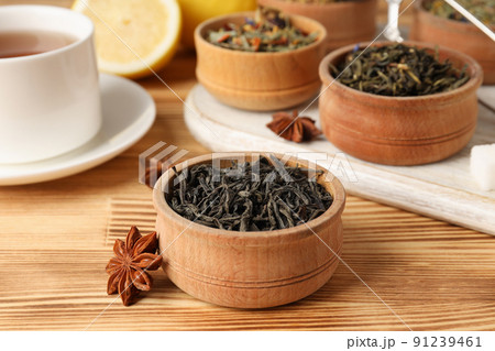 Concept of cooking tea with different types of tea on wooden background Concept of cooking tea with different types of tea on wooden background 91239461