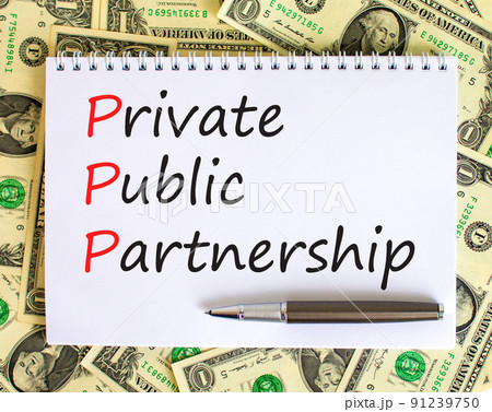 PPP private public partnership symbol. Concept words PPP private public partnership on white note on beautiful background from dollar bills. Business PPP private public partnership concept. Copy space PPP private public partnership symbol. Concept words PPP private public partnership on white note on beautiful background from dollar bills. Business PPP private public partnership concept. Copy space 91239750