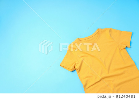 Blank yellow t-shirt with space for print on blue background Blank yellow t-shirt with space for print on blue background 91240481