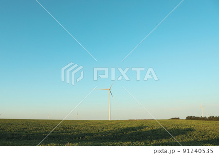 Windmills in field on blue sky background 91240535