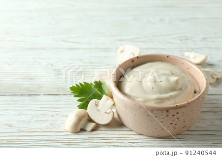 Concept of tasty food with mushroom sauce on white wooden background Concept of tasty food with mushroom sauce on white wooden background 91240544