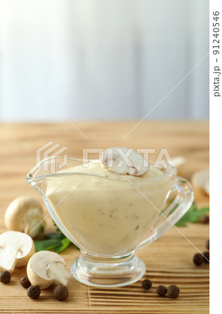 Concept of tasty food with mushroom sauce on wooden table Concept of tasty food with mushroom sauce on wooden table 91240546