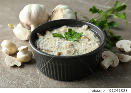 Concept of tasty food with mushroom sauce on gray textured background Concept of tasty food with mushroom sauce on gray textured background 91241323