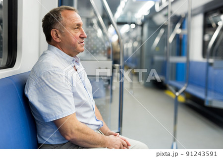 Middle aged man sitting in subway car Middle aged man sitting in subway car 91243591