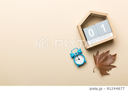 Calendar for September top view with copy space. Wooden calendar block with date 1 September with falling autumn leaves background Calendar for September top view with copy space. Wooden calendar block with date 1 September with falling autumn leaves background 91244677