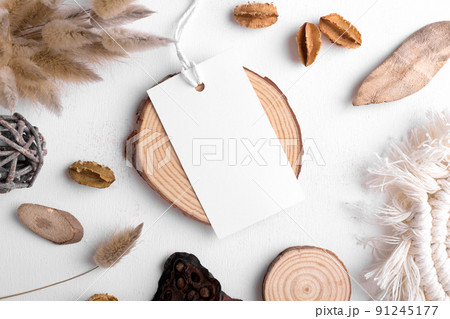 Rectangle white tag mockup on a white background with cotton string and boho decoration, dry plants, element for packing 91245177
