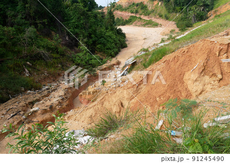 Erosion on the ground and slopes is caused by rainwater. The soil structure becomes weak and there is a landslide. Safety measure has been taken in some area. 91245490