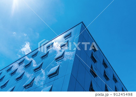 Looking up at the angle of modern business buildings in the city with blue tone Looking up at the angle of modern business buildings in the city with blue tone 91245498