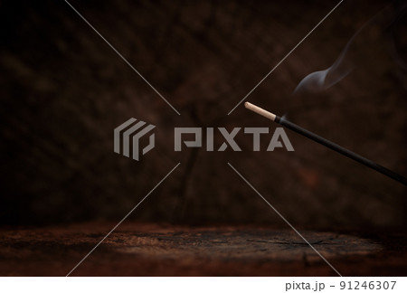 Lit incense on rustic dark wood background. Spiritual atmosphere, space for text. Lit incense on rustic dark wood background. Spiritual atmosphere, space for text. 91246307