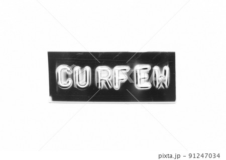 Black color banner that have embossed letter with word curfew on white paper background 91247034