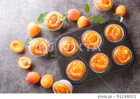 Apricot veggie muffins in a baking dish. horizontal top view 91248022