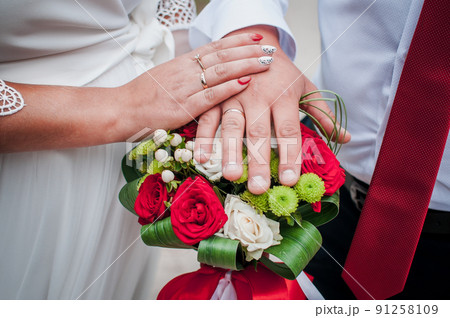 Groom nad bride hands lie on each other Groom nad bride hands lie on each other 91258109
