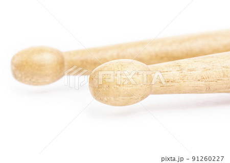 Two wooden drumsticks lying, isolated on a white background Two wooden drumsticks lying, isolated on a white background 91260227