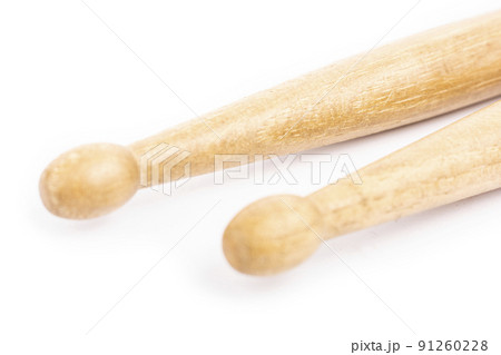 Two wooden drumsticks lying, isolated on a white background Two wooden drumsticks lying, isolated on a white background 91260228