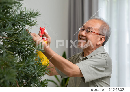 Asian elderly spending time to take care plant and flowers at home in retirement age. Happiness of senior man enjoy with hobby smile and laughing. Retirement activities and lifestyle Asian elderly spending time to take care plant and flowers at home in retirement age. Happiness of senior man enjoy with hobby smile and laughing. Retirement activities and lifestyle 91268024