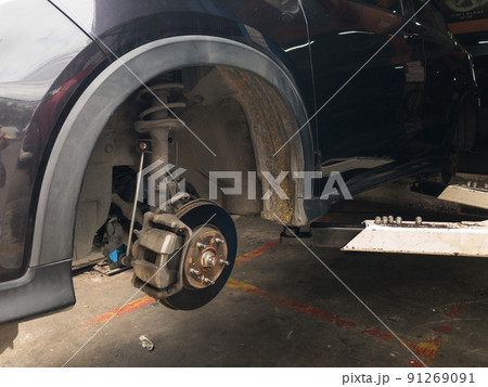 Lift is lifting a black car, removing the wheels, a car suspension repair concept. tire change 91269091
