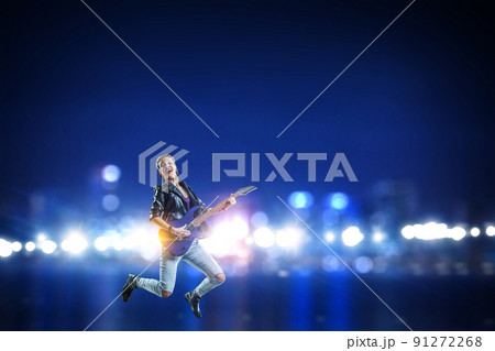 Young and beautiful rock girl playing the electric guitar Young and beautiful rock girl playing the electric guitar 91272268