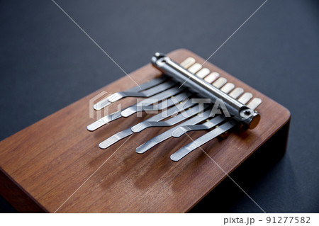Traditional wooden kalimba isolated on black Traditional wooden kalimba isolated on black 91277582