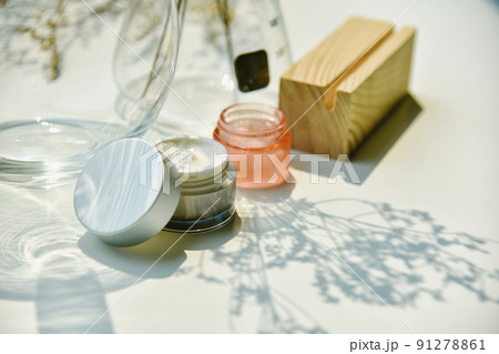 Cosmetic bottle container on sunlight and leaves plant shadow background, Skincare facial cream 91278861