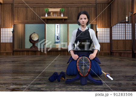 神棚がある剣道場で真剣な顔をして防具を身につけ正座をする女の子 91283506