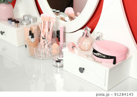 Dressing table with mirror and makeup products, closeup 91284145