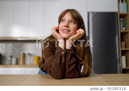 Portrait of thinking housewife in kitchen Portrait of thinking housewife in kitchen 91285318