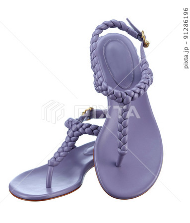 Beautiful pair of elegant women's summer sandals made of purple leather with braided leather straps on a low heel, highlighted on a white background. Vertical. The trend of the summer season. 91286196